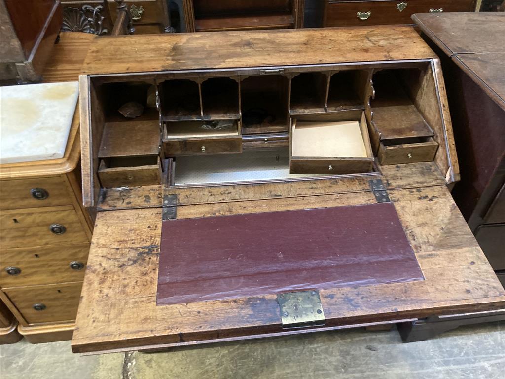 A George III mahogany bureau, with brass swing handles, on bracket feet, width 90cm, depth 50cm, height 96cm